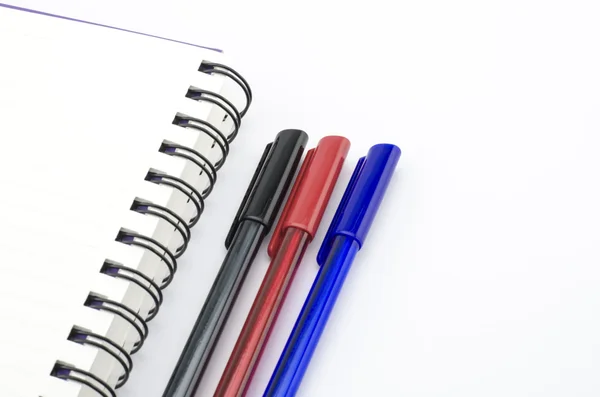 Black red and blue pen with notebook isolated on white — Stock Photo, Image