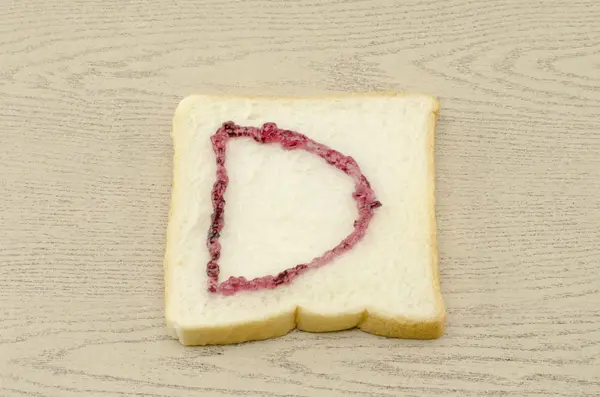 Jam alphabet on sliced bread — Stock Photo, Image