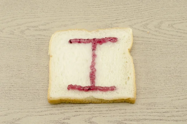 Jam alphabet on sliced bread — Stock Photo, Image