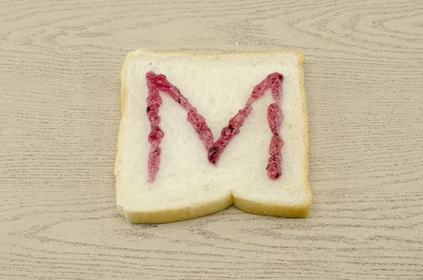 Jam alphabet on sliced bread — Stock Photo, Image