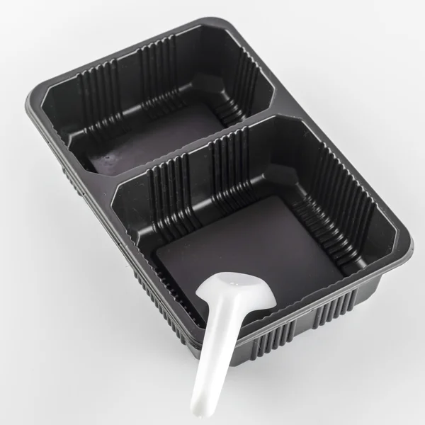 Black tray with spoon — Stock Photo, Image