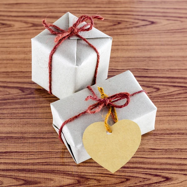 Braune Geschenkbox mit Herz-Etikett-Karte — Stockfoto