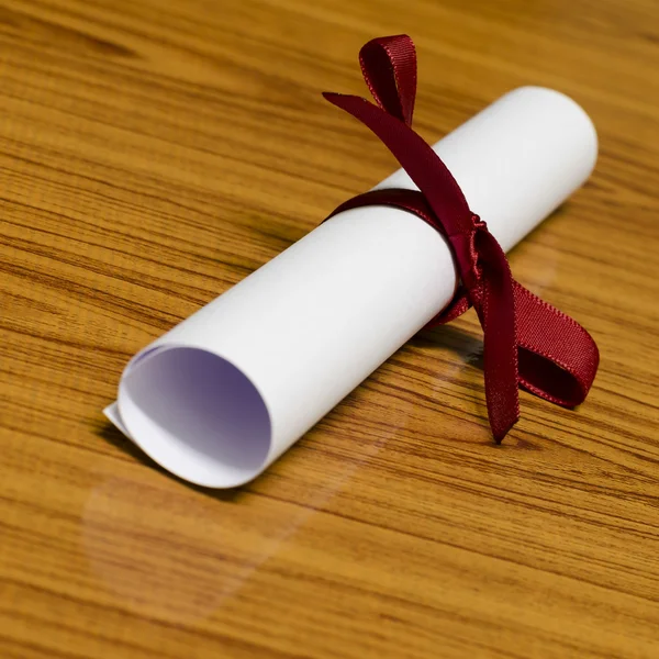 Diploma with red bow — Stock Photo, Image