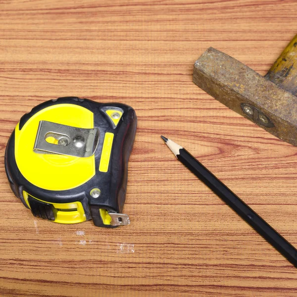 Hammer measuring tape and pencil — Stock Photo, Image