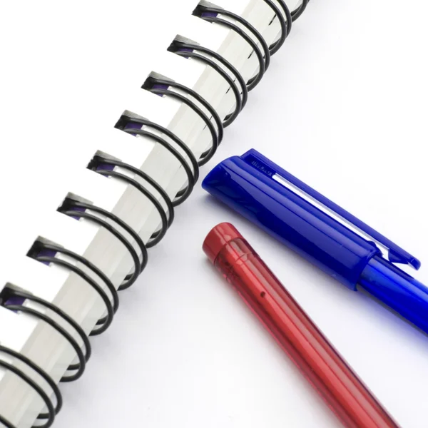 Red and blue pen with notebook isolated on white — Stock Photo, Image