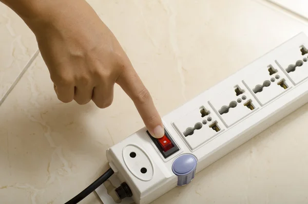 Hand turn on switch multiple  socket plug — Stock Photo, Image