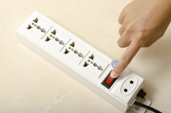 Hand turn on switch multiple  socket plug — Stock Photo, Image