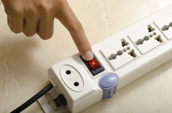 Hand turn on switch multiple socket plug — Stock Photo, Image
