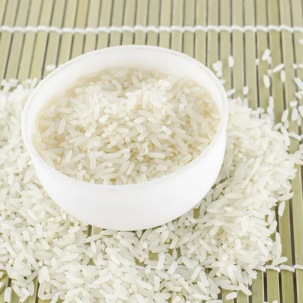 Uncooked rice in mini bowl — Stock Photo, Image