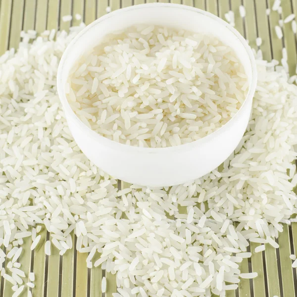 Uncooked rice in mini bowl — Stock Photo, Image