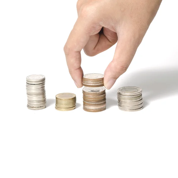 Mão colocando pilha de moedas — Fotografia de Stock