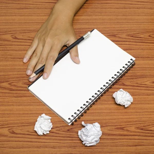 Hand writing on notebook with crumpled paper — Stock Photo, Image