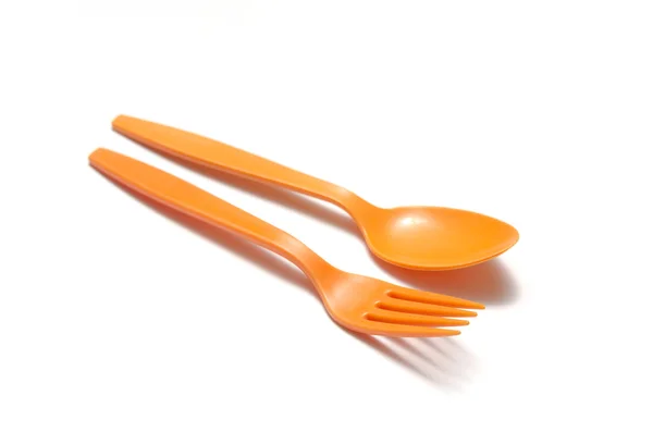 Orange plastic spoon and fork — Stock Photo, Image