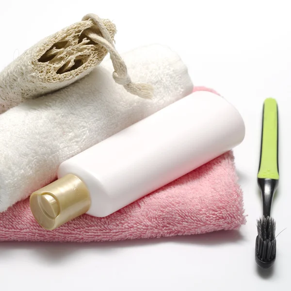 Towel loofah liquid soap and toothbrush — Stock Photo, Image