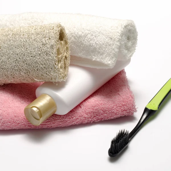 Towel loofah liquid soap and toothbrush — Stock Photo, Image