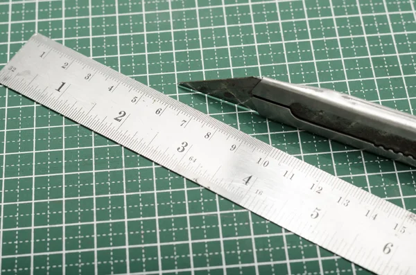 Ruler and cutter on cutting mat — Stock Photo, Image