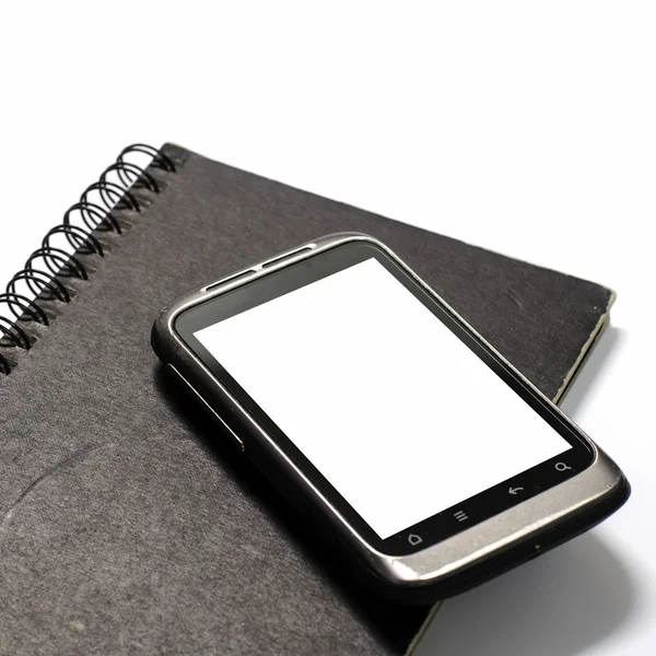 Smartphone on note book — Stock Photo, Image
