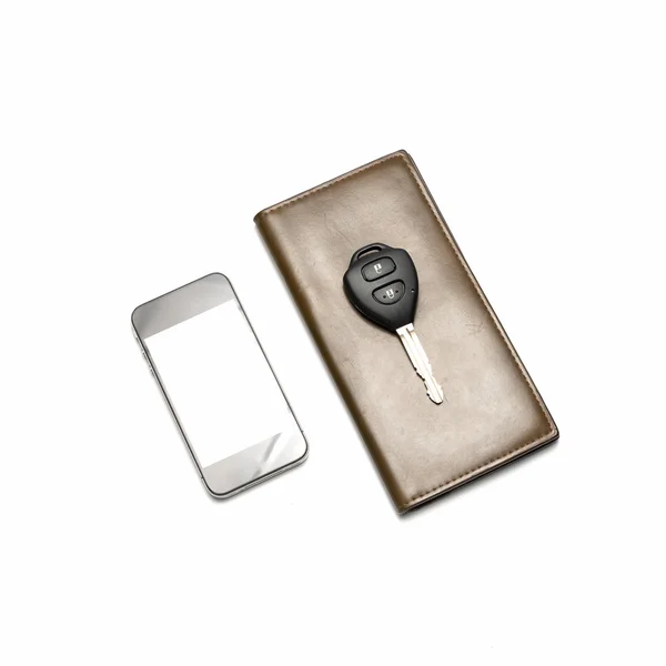 Smartphone mit Autoschlüssel im braunen Portemonnaie — Stockfoto