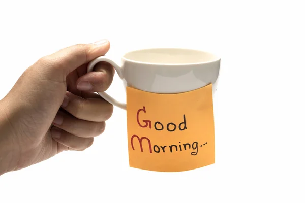 Mano tenendo tazza di caffè con nota adesiva scrivere Buongiorno — Foto Stock