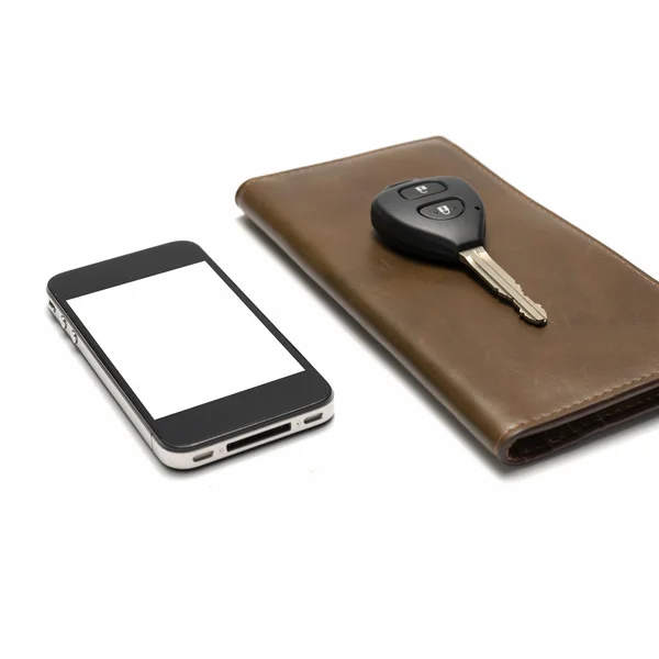 Slimme telefoon met auto sleutel op bruin portemonnee — Stockfoto