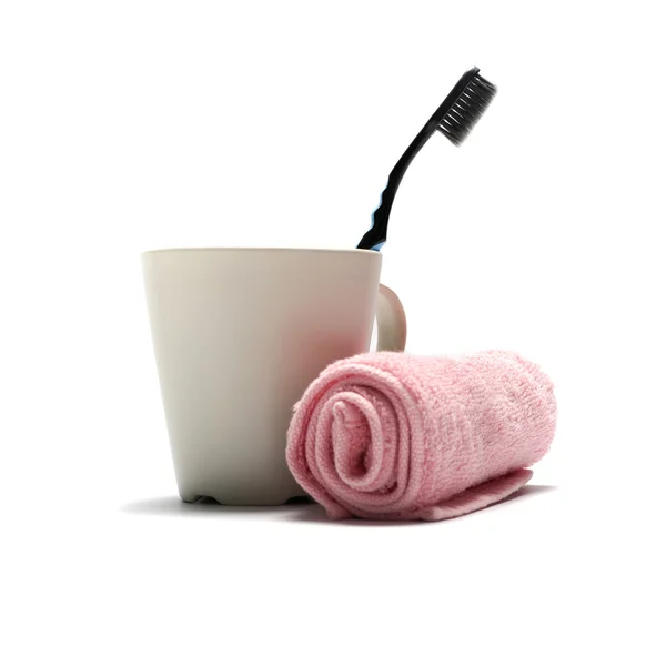 Tooth brush and towel with mug — Stock Photo, Image