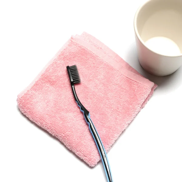 Tooth brush and towel with mug — Stock Photo, Image