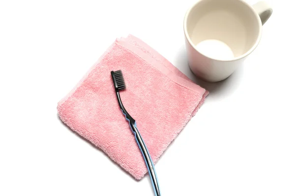 Tooth brush and towel with mug — Stock Photo, Image