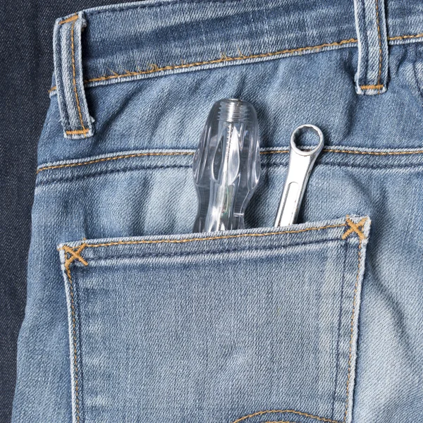 Screwdriver in jean — Stock Photo, Image