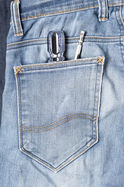 Screwdriver in jean — Stock Photo, Image