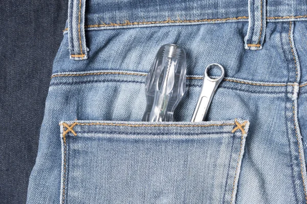 Screwdriver in jean — Stock Photo, Image