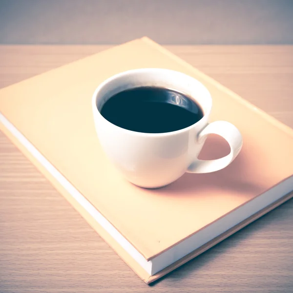 Чашка кофе на оранжевой книге — стоковое фото