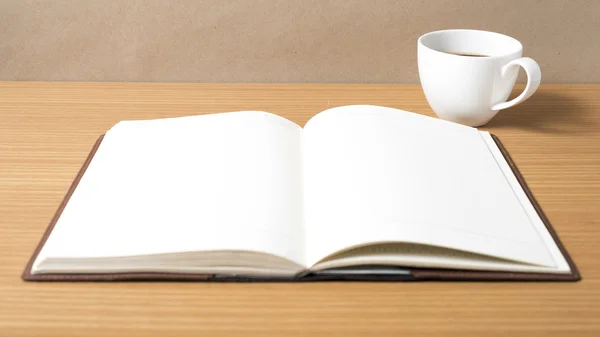 Open book with coffee cup — Stock Photo, Image