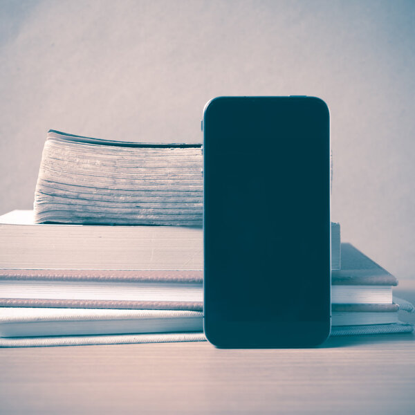 stack of book and smart phone vintage style