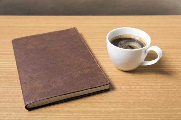 Libro marrone con caffè nero — Foto Stock