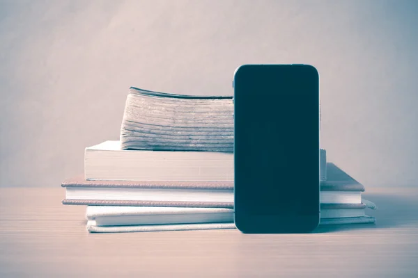Stack of book and smart phone vintage style Stock Image