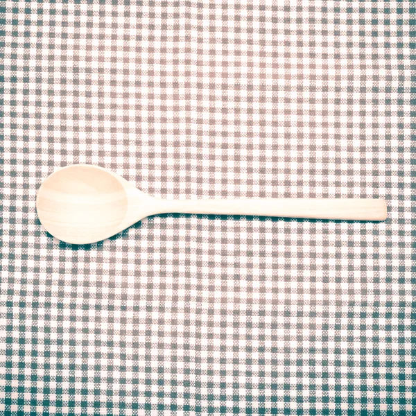 Wood spoon on kitchen towel — Stock Photo, Image