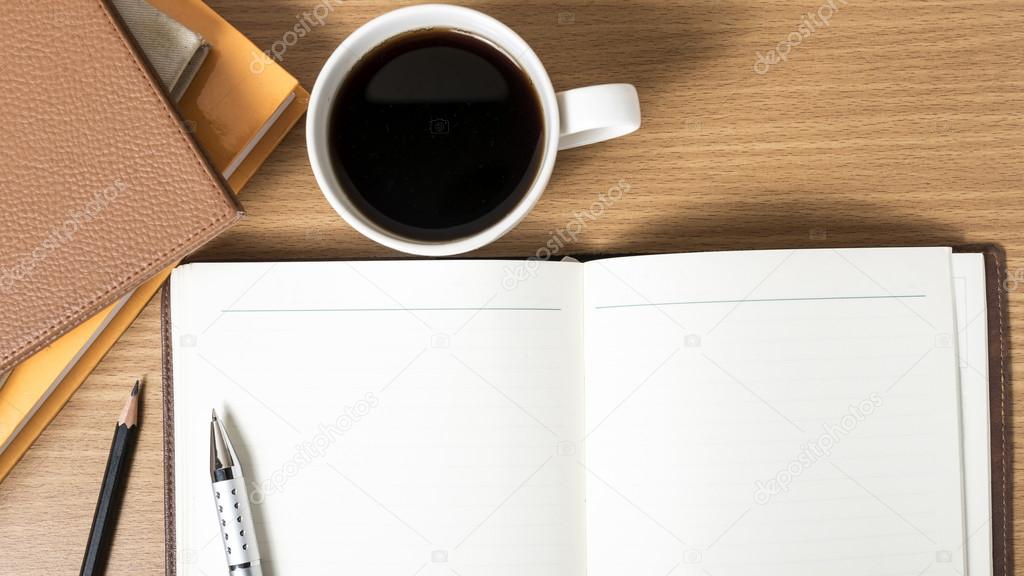 Open notebook with coffee cup