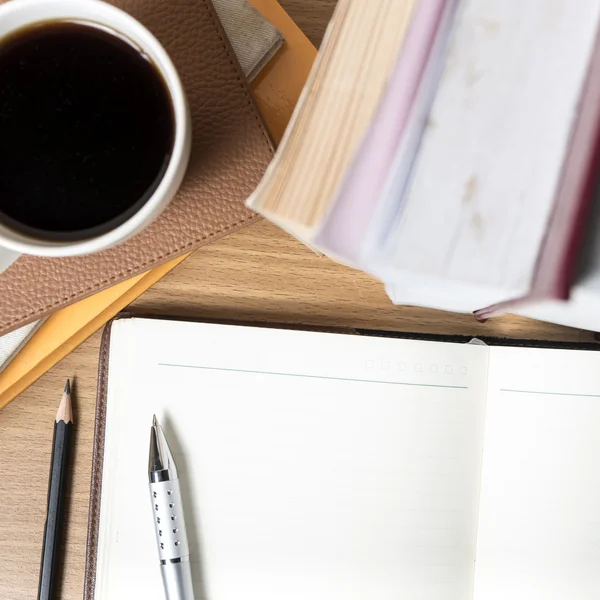 Notitieblok openen met boek en koffie beker — Stockfoto