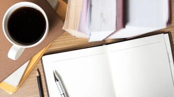 Notitieblok openen met boek en koffie beker — Stockfoto