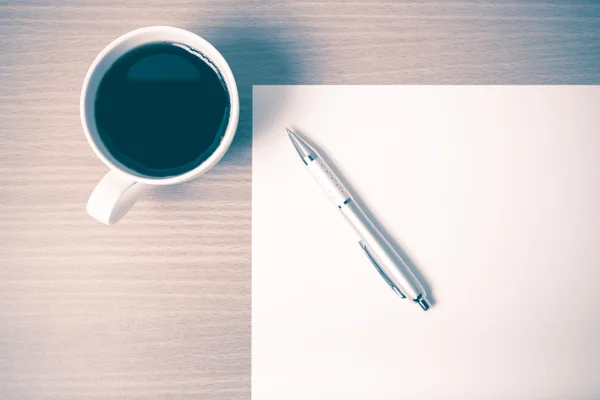 Чашка кофе с белой бумагой и ручкой винтажного стиля — стоковое фото