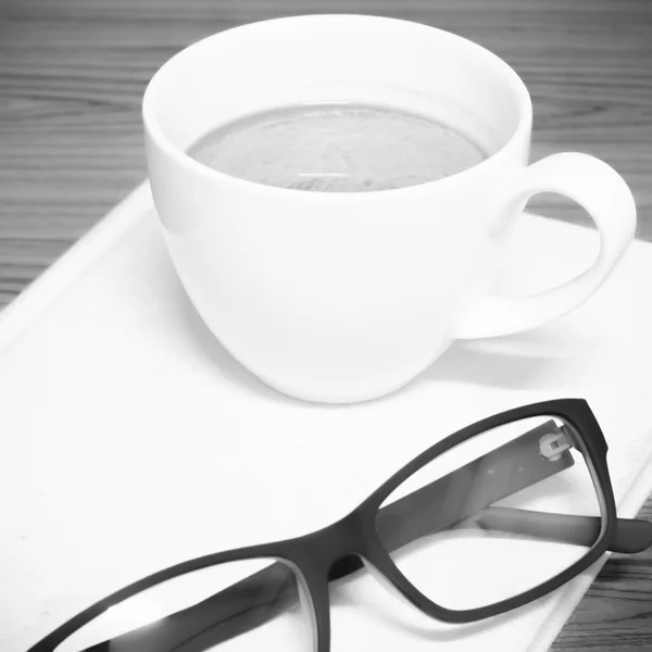 Coffee cup and notebook with glasses black and white color tone — Stock Photo, Image