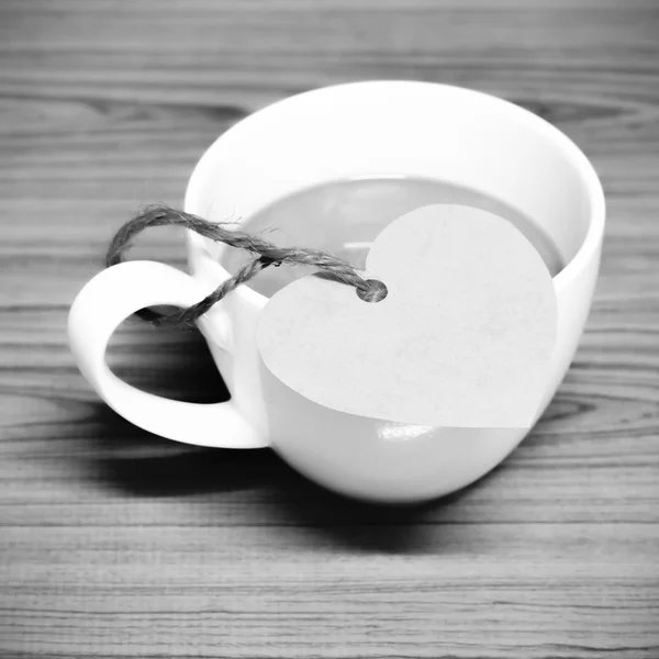 Coffee cup with heart tag black and white color tone style — Stock Photo, Image