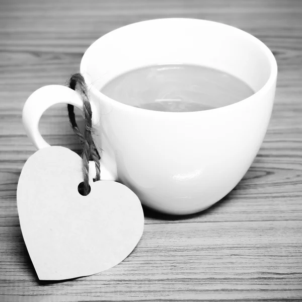 Coffee cup with heart tag black and white color tone style — Stock Photo, Image