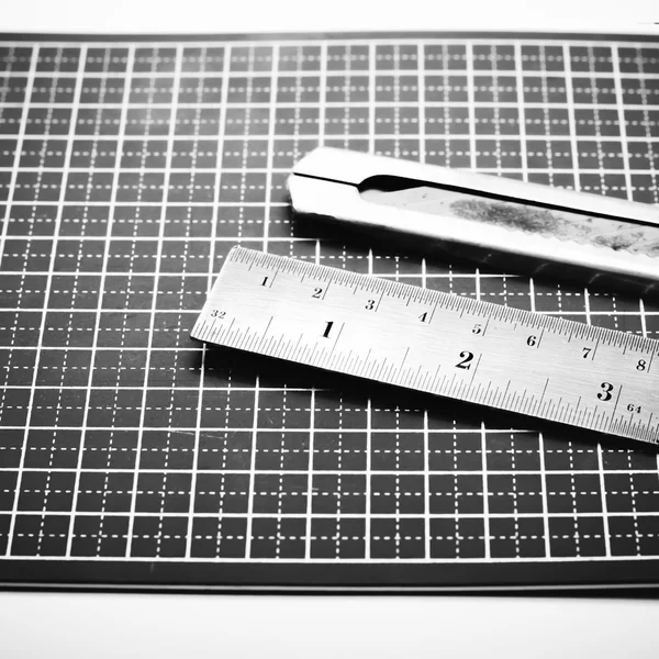 Ruler and cutter on cutting mat black and white color tone style — Stock Photo, Image