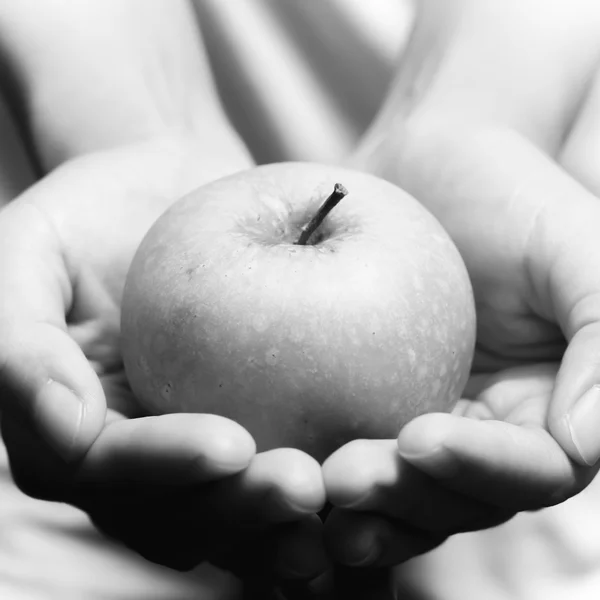 Hand holding apple fruit black and white color tone style — Stock Photo, Image