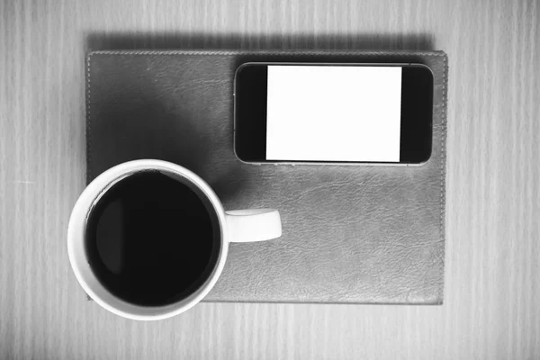 Smart phone and coffee cup on book black and white color tone st — Stock Photo, Image