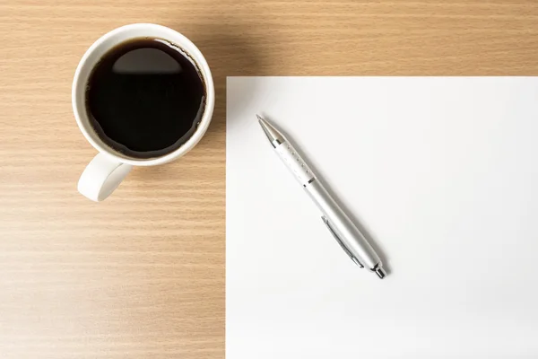 Coffee cup with white paper and pen Stock Image