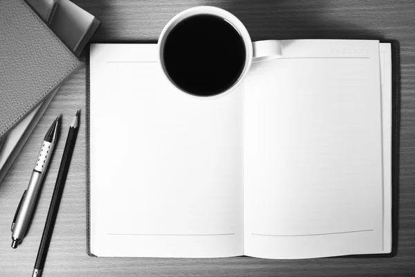 Open notebook with book and coffee cup  black and white color to — Stock Photo, Image
