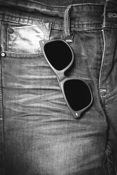 Sunglasses on jean pants black and white tone color style — Stock Photo, Image