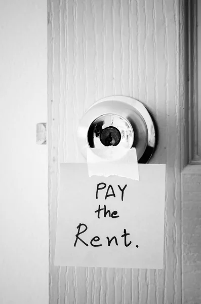 Sticky note write a message pay the rent black and white color t — Stock Photo, Image